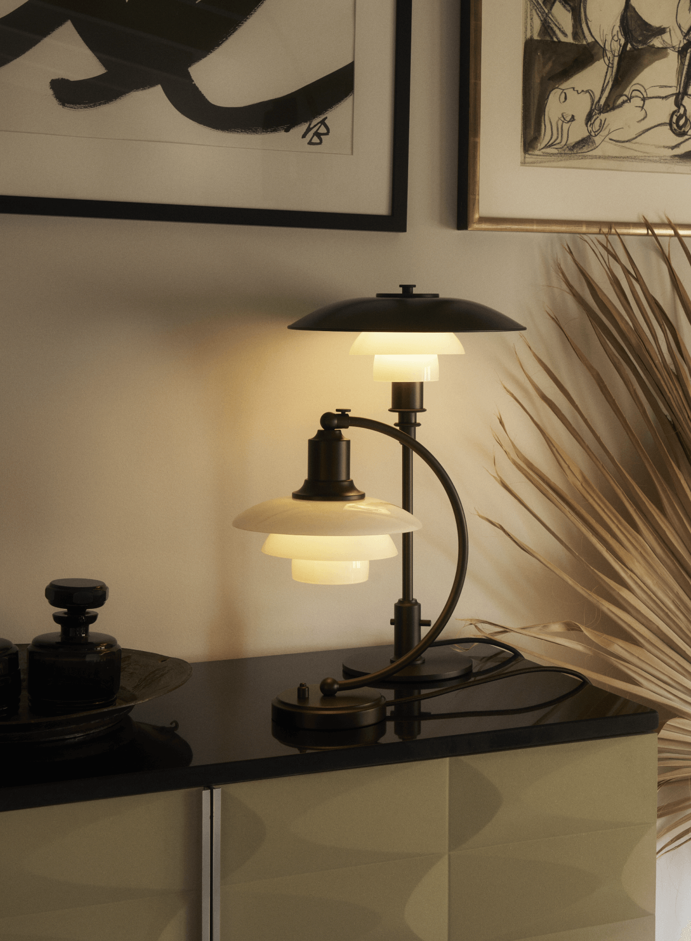 PH Aged Brass Opal table lamps on a coffee table in a chic interior, © 2025 Louis Poulsen."