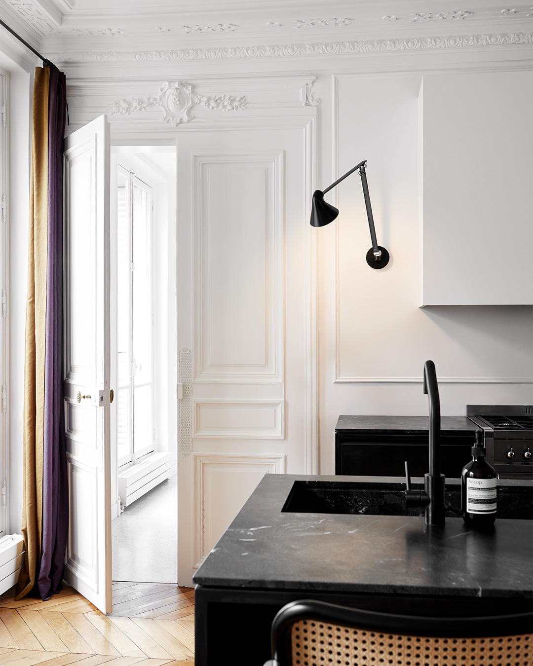 NJP Wall in Black mounted above kitchen worktop, © 2025 Louis Poulsen.