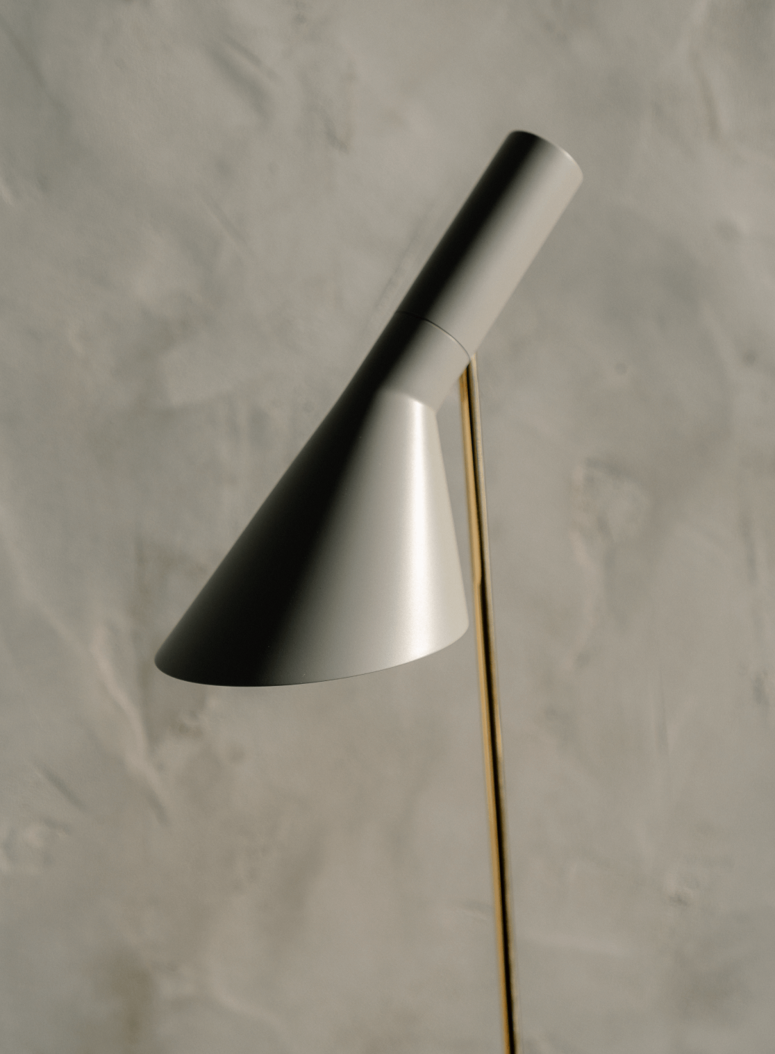 Detail of AJ Floor lamp with brass stem and matte grey shade, © 2025 Louis Poulsen.
