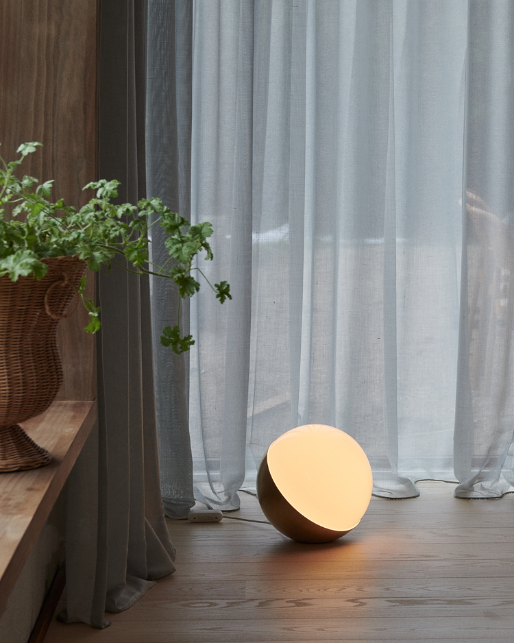 VL Studio Floor lamp glowing near sheer curtains and wooden floor, © 2025 Louis Poulsen.