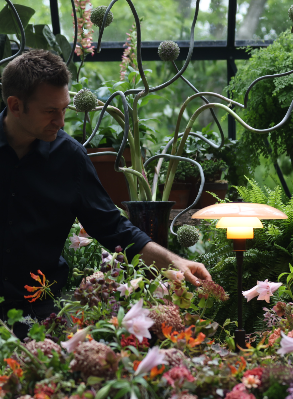 PH 3/2 Limited Edition Table Lamp glowing beside Nicolai Bergmann arranging flowers, © 2025 Louis Poulsen.
